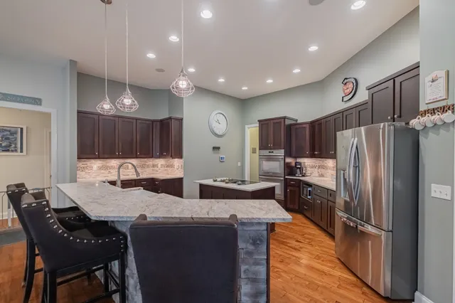a large kitchen with a table and chairs