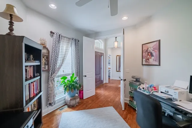 a view of a workspace with furniture and bookshelf