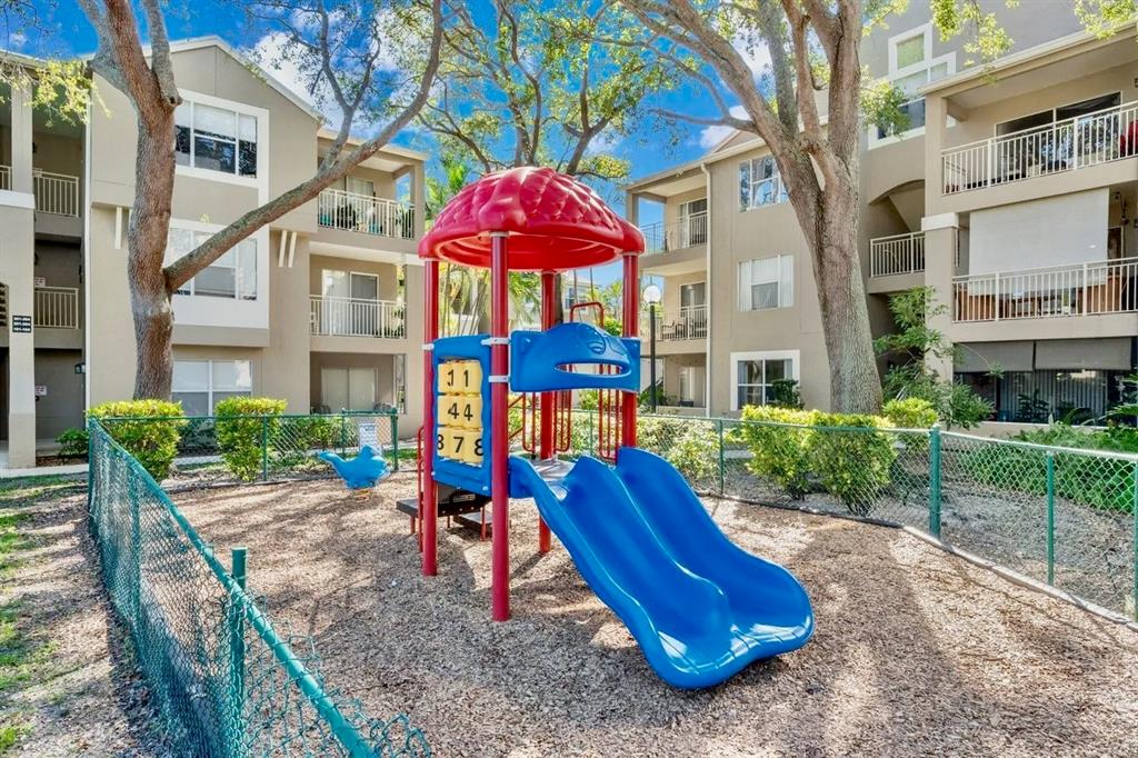 1780 Palm Cove Boulevard, Unit 6308 Delray Beach, FL 33445 - Photo 11 of 12 a view of a house with a backyard and plants