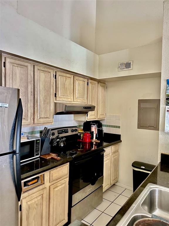 1780 Palm Cove Boulevard, Unit 6308 Delray Beach, FL 33445 - Photo 6 of 12 a kitchen with granite countertop a refrigerator stove and sink