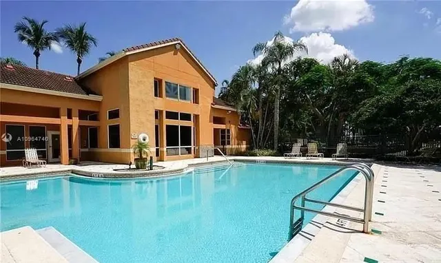 a view of a patio with swimming pool table and chairs