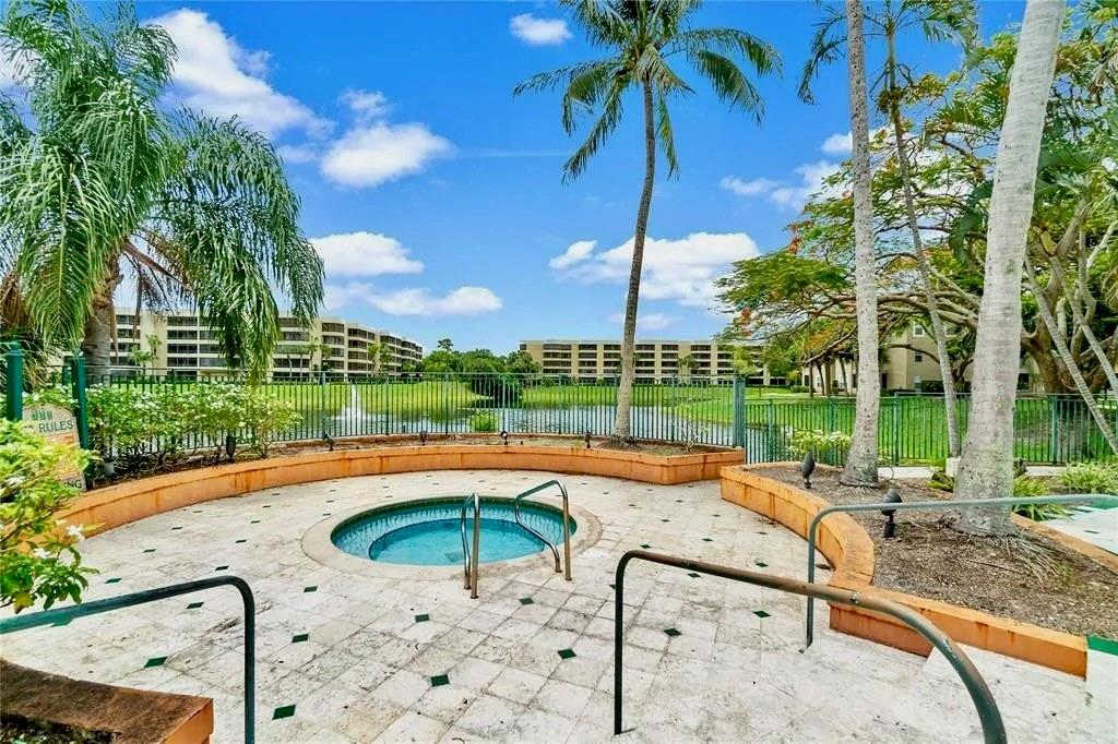 1780 Palm Cove Boulevard, Unit 6308 Delray Beach, FL 33445 - Photo 9 of 12 a view of swimming pool with a patio