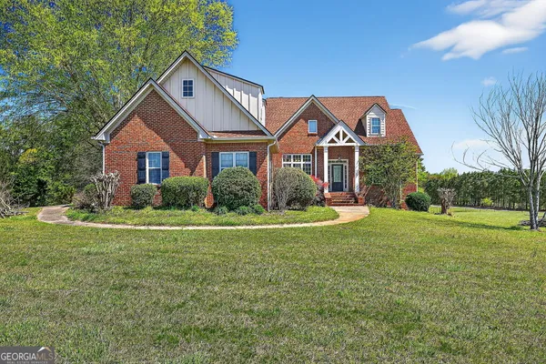a front view of house with yard and green space