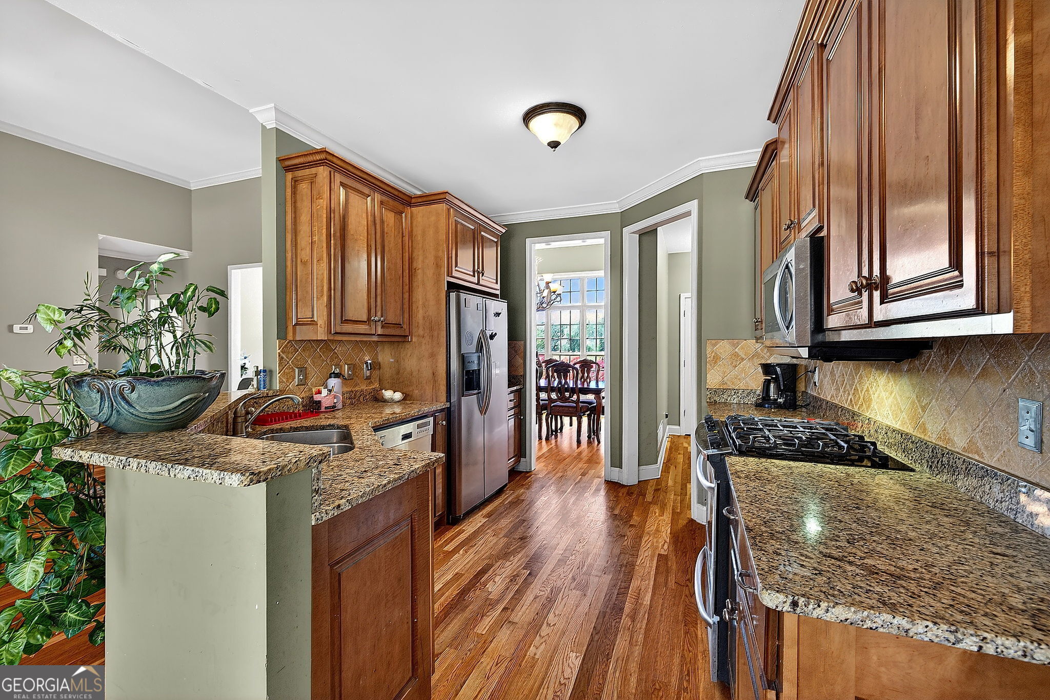 360 Happy Hill Road Carrollton, GA 30116 - Photo 14 of 50 a kitchen with granite countertop kitchen island stainless steel appliances a stove a sink and a refrigerator