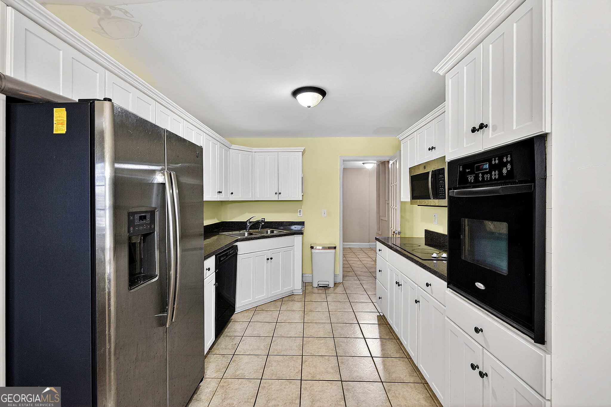 360 Happy Hill Road Carrollton, GA 30116 - Photo 29 of 50 a kitchen with stainless steel appliances a refrigerator sink and cabinets