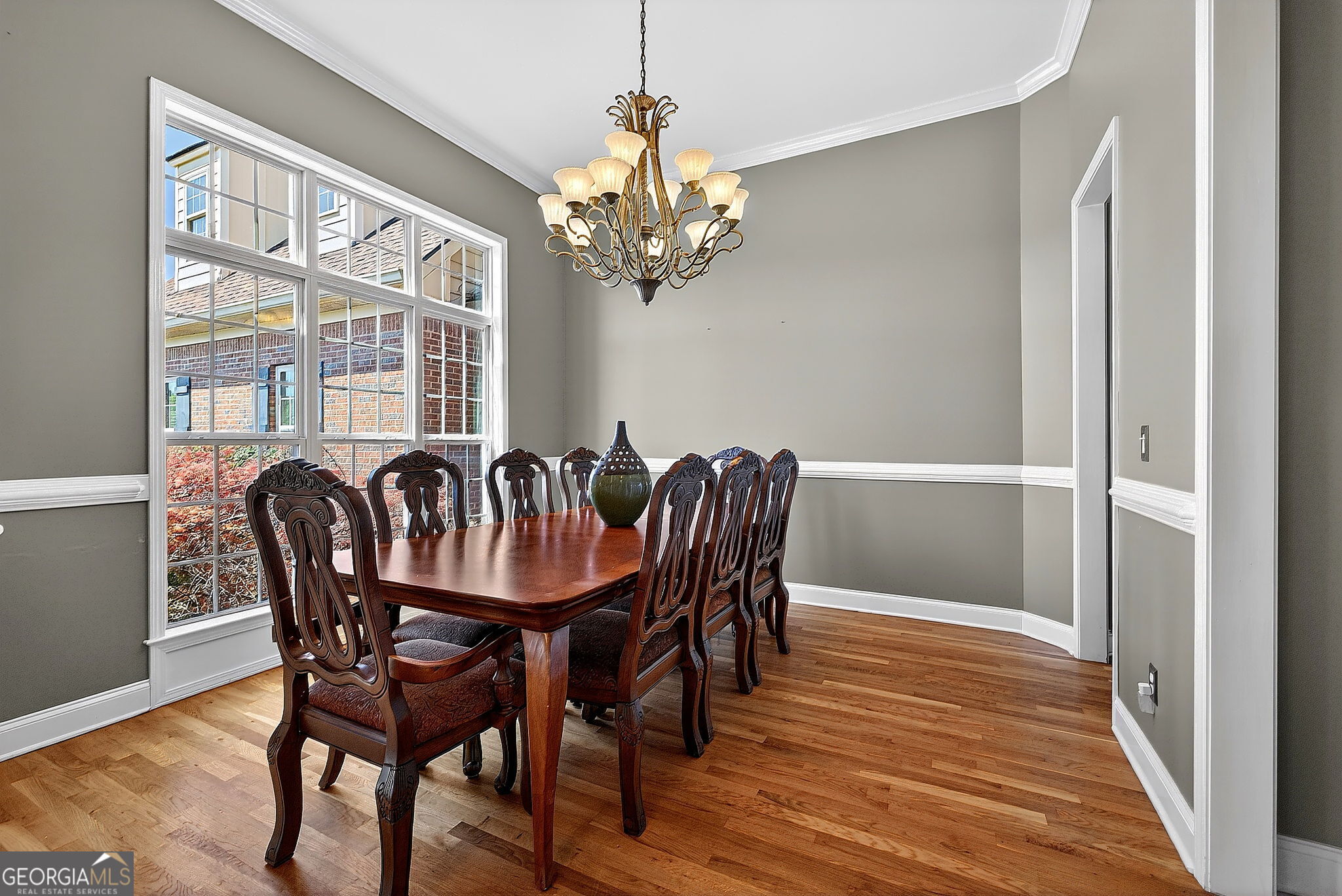 360 Happy Hill Road Carrollton, GA 30116 - Photo 7 of 50 a view of a dining room with furniture a chandelier and wooden floor