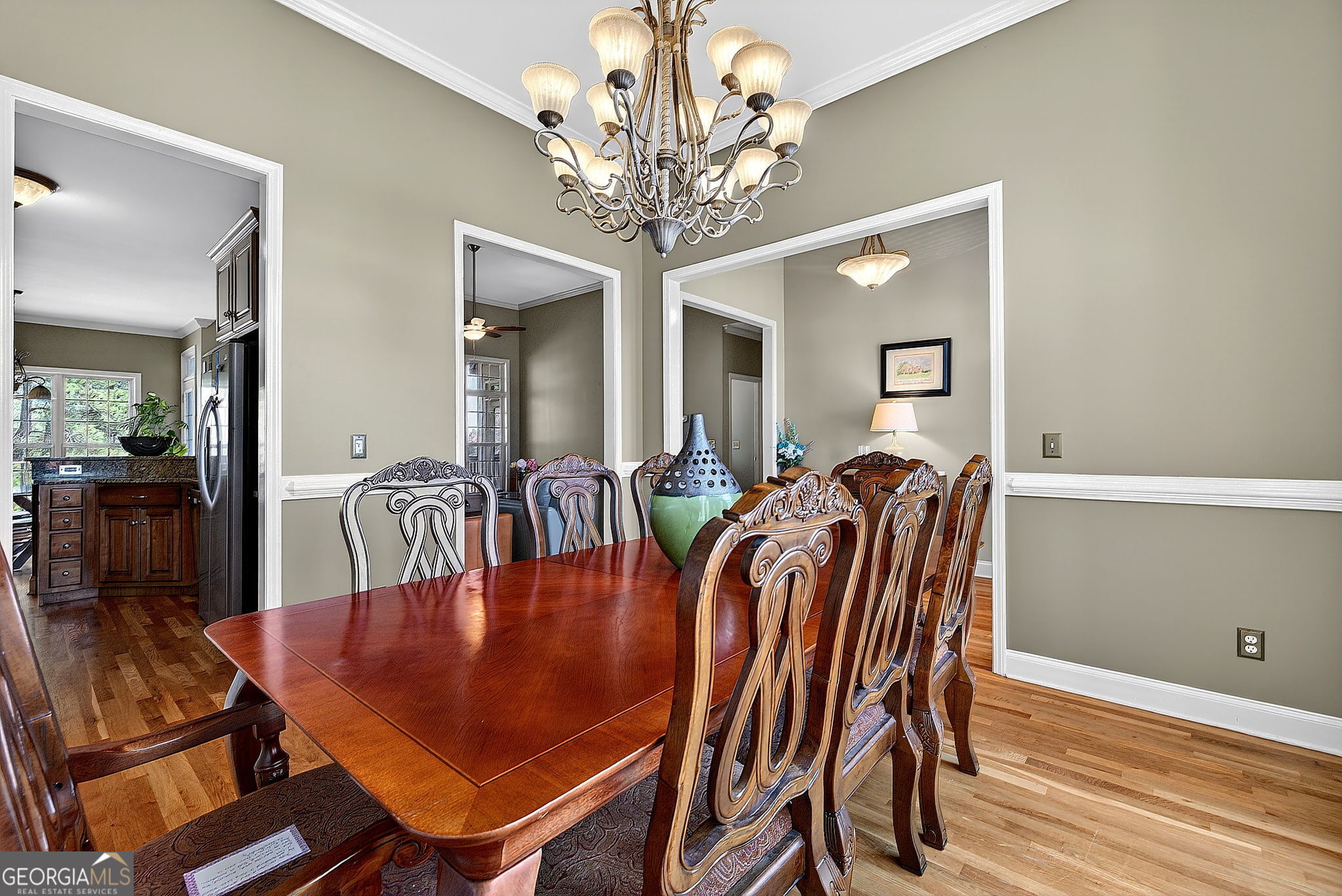 360 Happy Hill Road Carrollton, GA 30116 - Photo 8 of 50 a dining room with wooden floor a chandelier a glass table and chairs