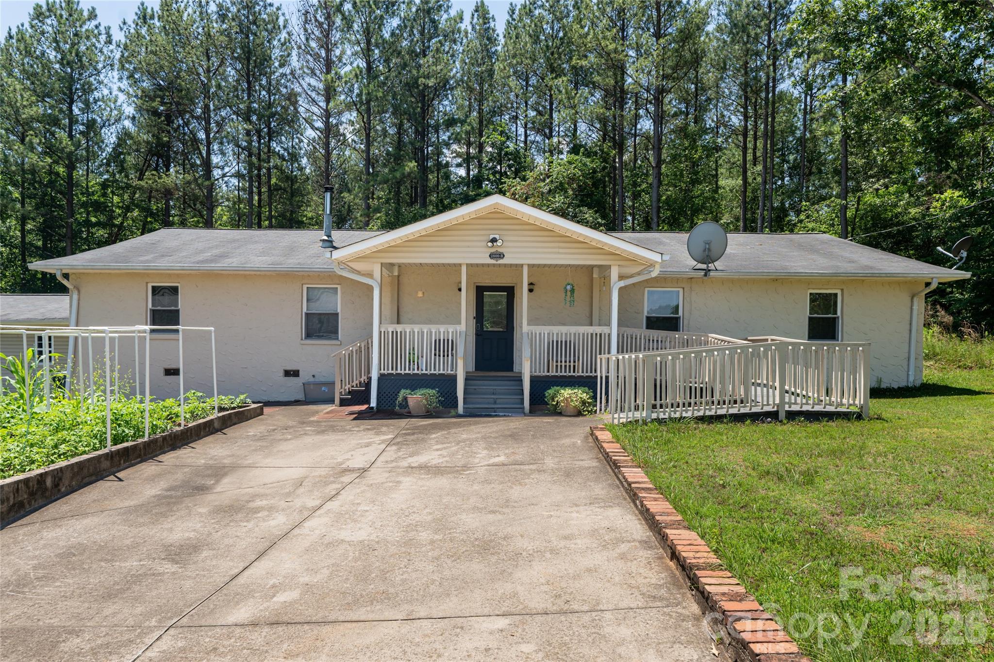 2800 Coxe Road Tryon, NC 28782 - Photo 26 of 40 a front view of a house with yard patio and green space