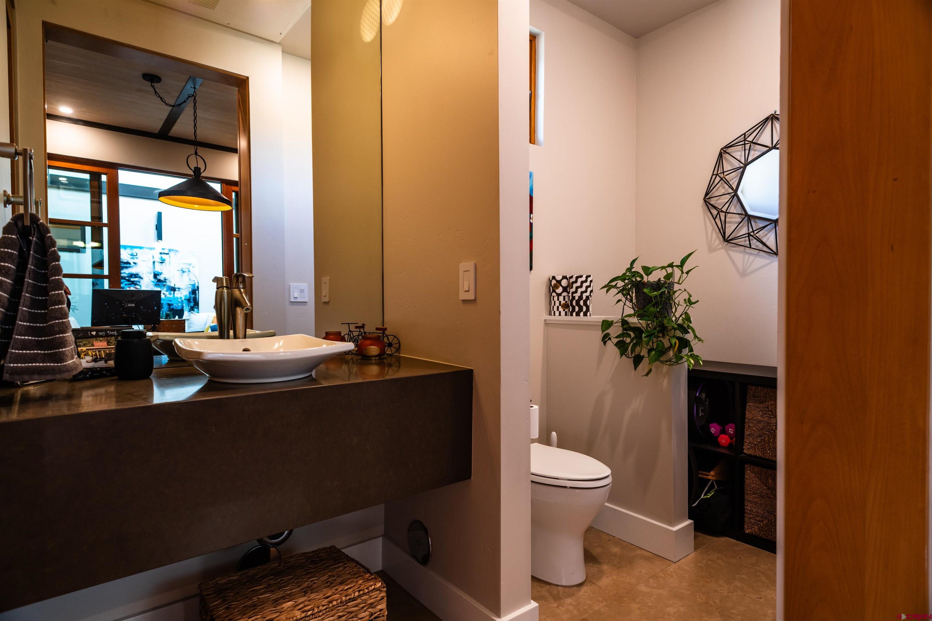 235 Rock Point Drive, Unit 235B Durango, CO 81301 - Photo 15 of 37 a bathroom with a sink a toilet and a mirror