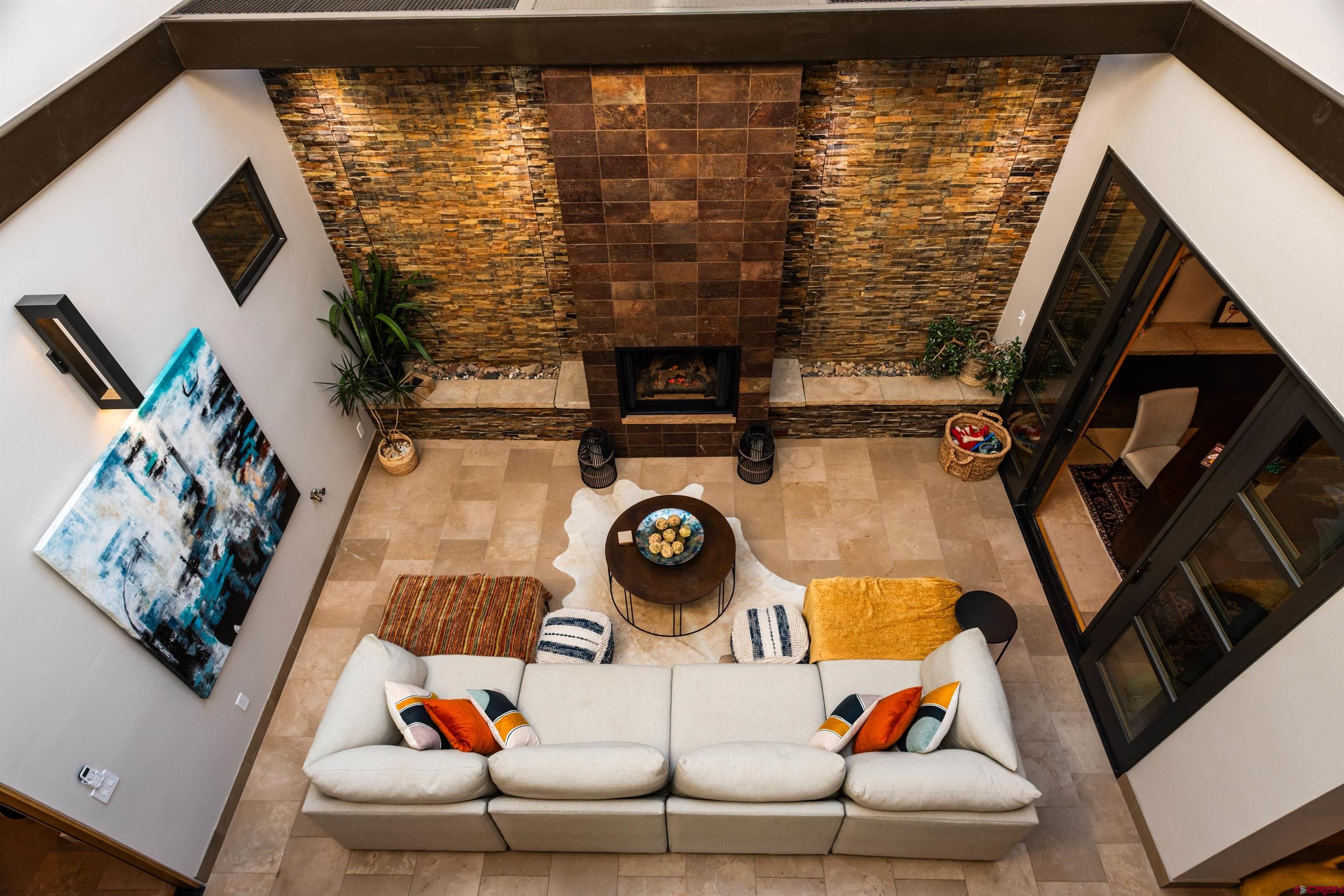 235 Rock Point Drive, Unit 235B Durango, CO 81301 - Photo 19 of 37 a living room with furniture and a fireplace
