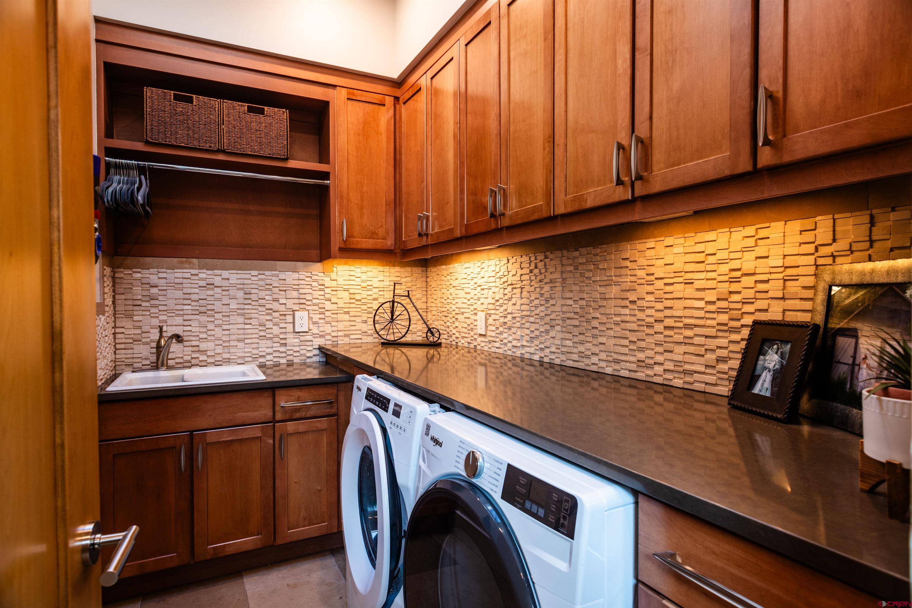 235 Rock Point Drive, Unit 235B Durango, CO 81301 - Photo 26 of 37 a utility room with cabinets
