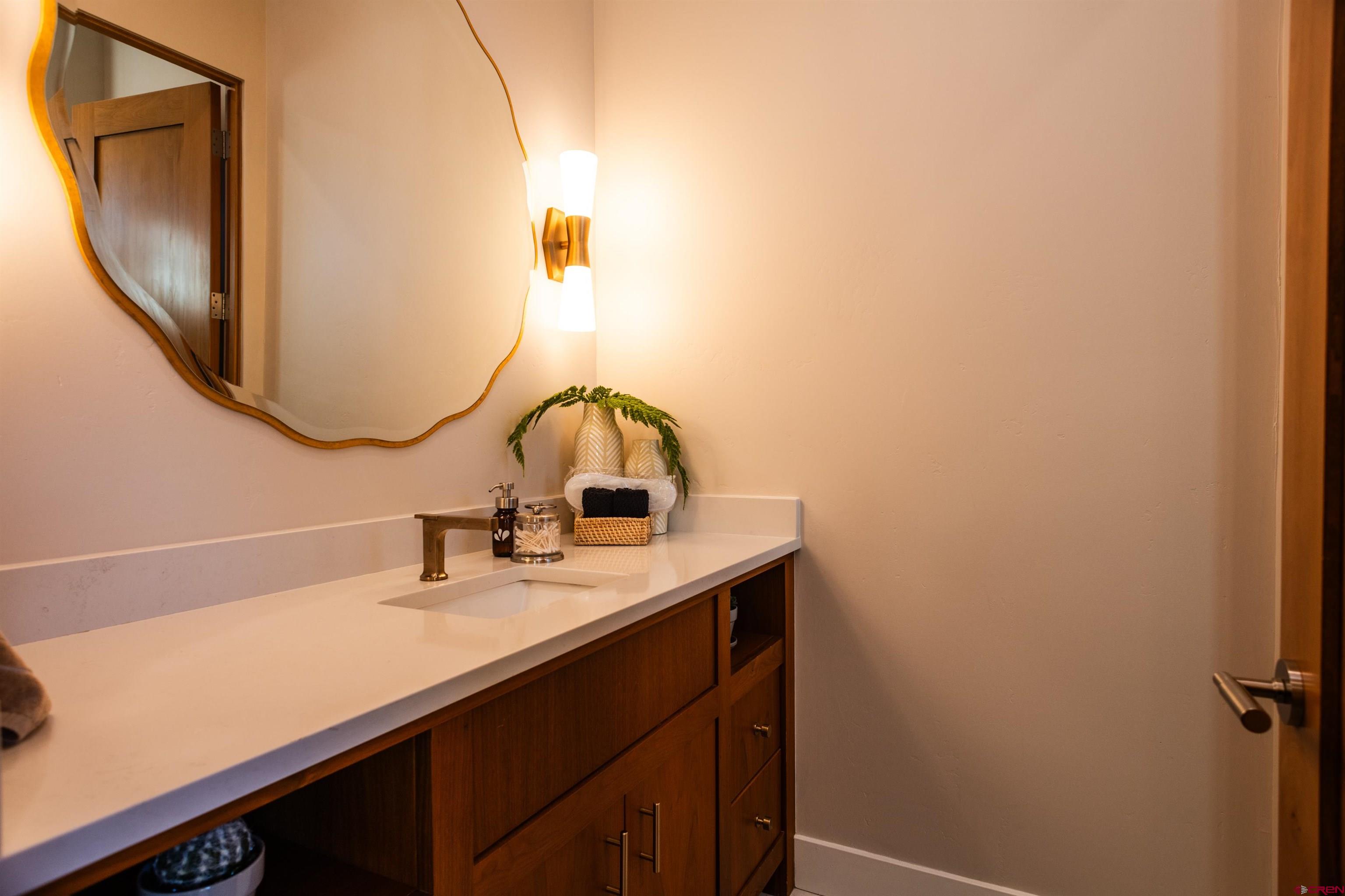 235 Rock Point Drive, Unit 235B Durango, CO 81301 - Photo 29 of 37 a bathroom with a sink and a mirror