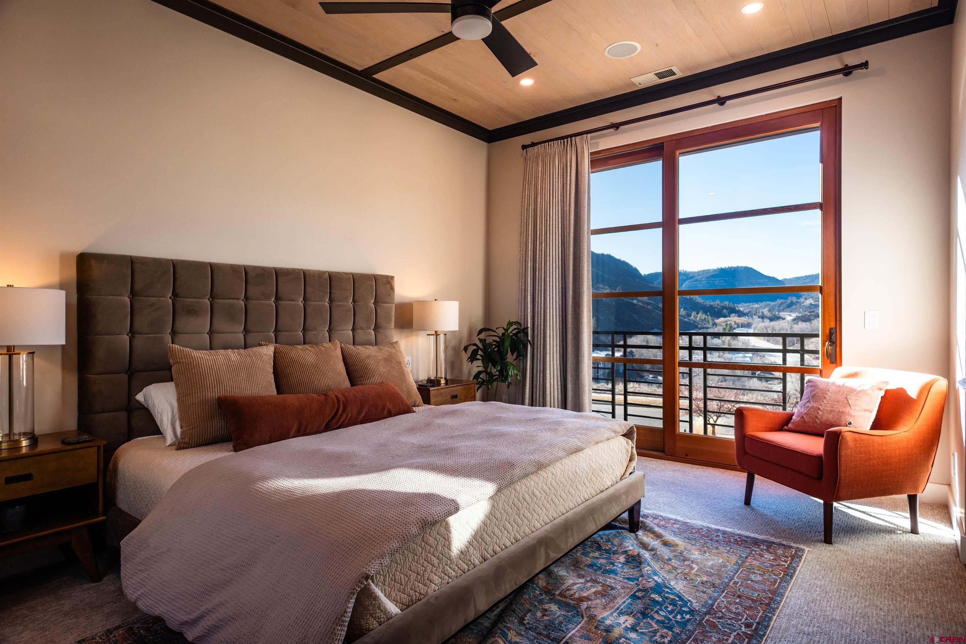 235 Rock Point Drive, Unit 235B Durango, CO 81301 - Photo 31 of 37 a bedroom with a bed and a couch