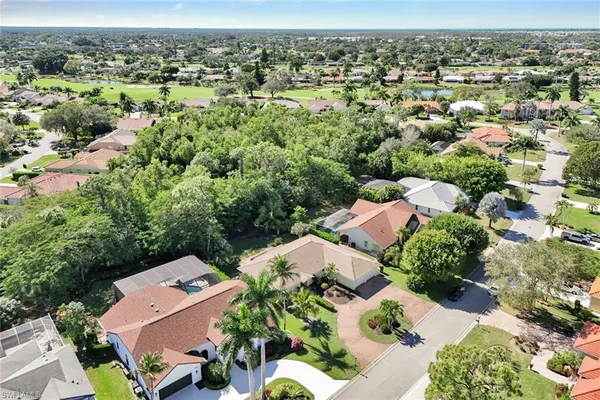 an aerial view of a houses with a yard