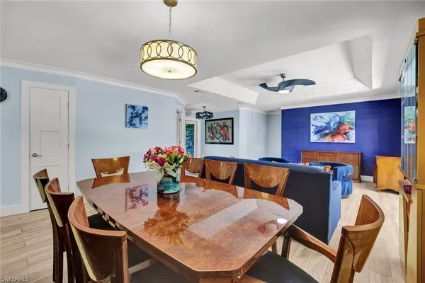 a view of a dining room with furniture and chandelier