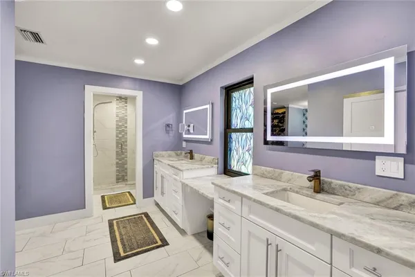 a spacious bathroom with a granite countertop sink and a mirror