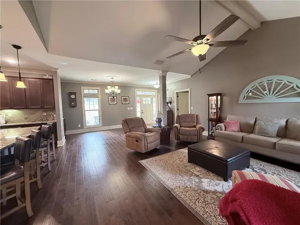 a living room with furniture and a chandelier