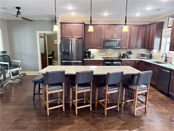 a kitchen with granite countertop wooden cabinets and a sink