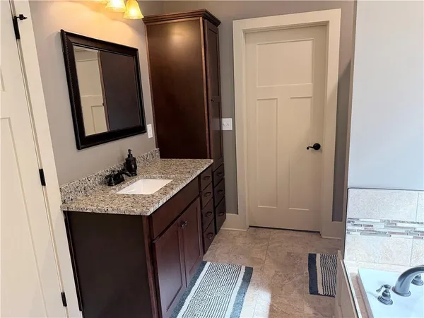 a kitchen with stainless steel appliances granite countertop a sink stove and cabinets