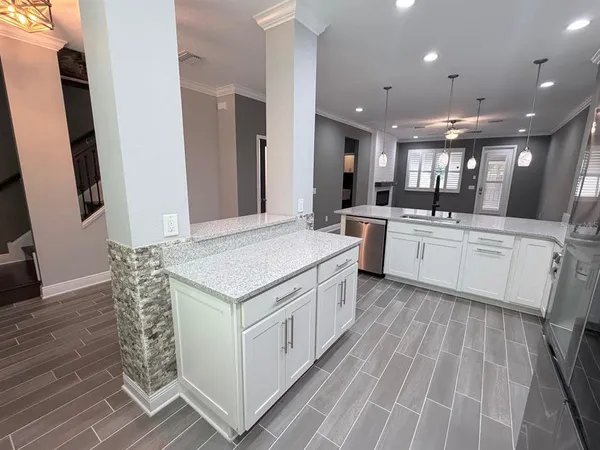 a kitchen with stainless steel appliances granite countertop a refrigerator and a sink