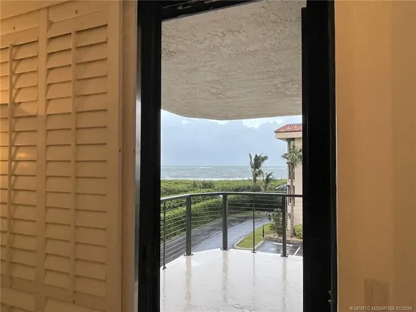 a view of a glass door and the balcony