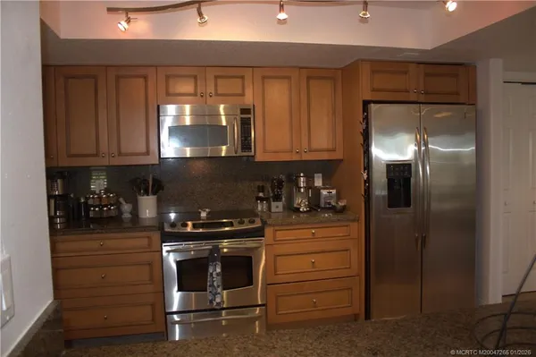a kitchen with a refrigerator and a stove
