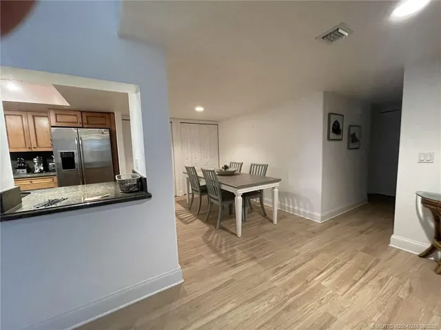 a living room with furniture a wooden floor and a sink