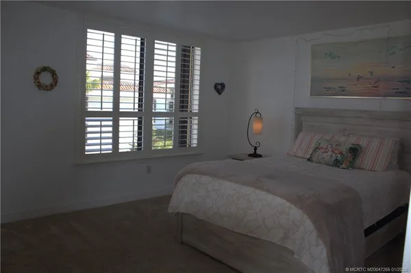 a bedroom with bed and window