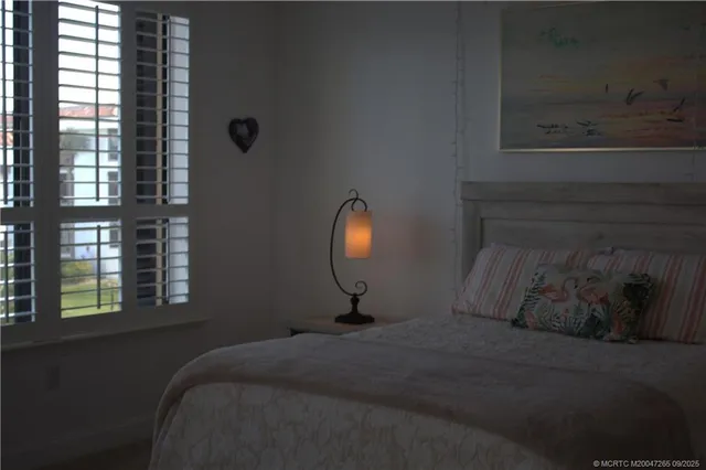 a bed sitting in a bedroom next to a window