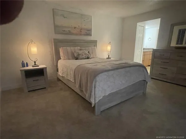 a bedroom with a bed and lamp