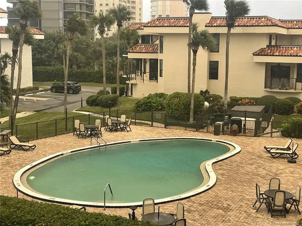 a view of a swimming pool with a patio