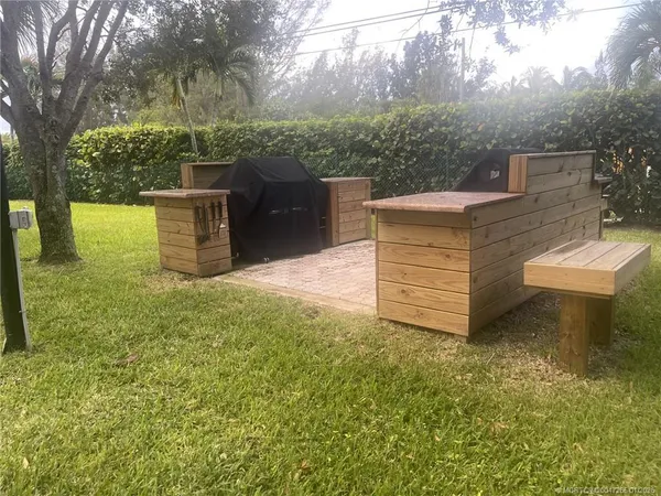 a view of a chairs and table in the garden