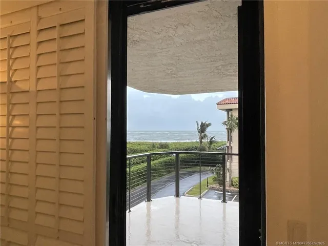 a view of a glass door and the balcony