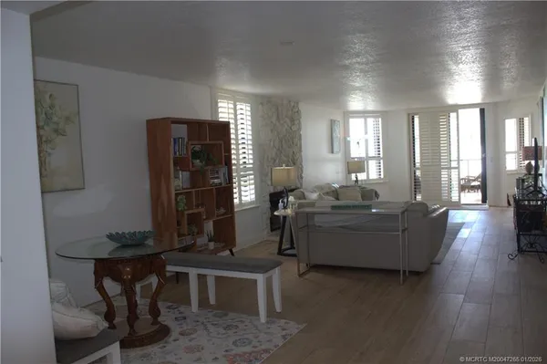 a living room with furniture and wooden floor