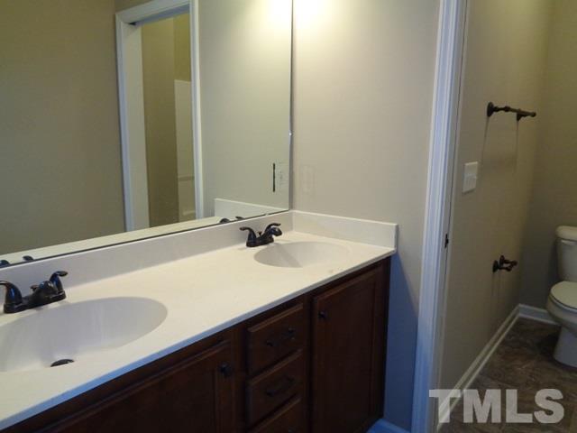 111 Torpoint Road Durham, NC 27703 - Photo 13 of 25 a bathroom with a sink and a mirror