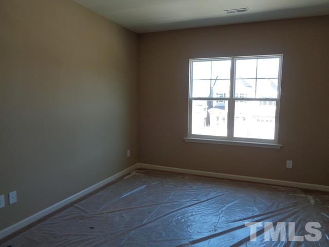 111 Torpoint Road Durham, NC 27703 - Photo 14 of 25 an empty room with wooden floor and windows