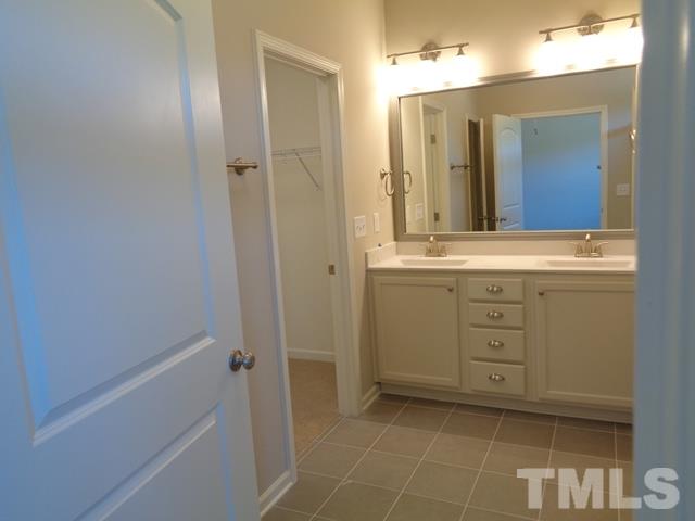 111 Torpoint Road Durham, NC 27703 - Photo 8 of 25 a bathroom with a sink a vanity and a mirror