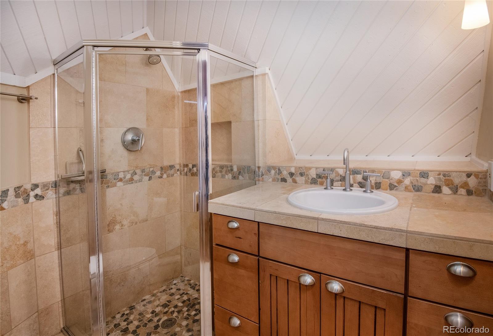 1400 Lions Ridge Loop, Unit A5 Vail, CO 81657 - Photo 15 of 28 a bathroom with a granite countertop sink a shower and a mirror