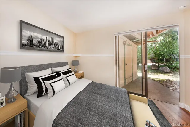 a bedroom with a bed and glass door