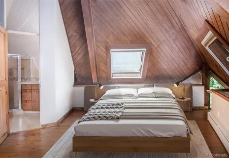 a bedroom with a bed and a rug