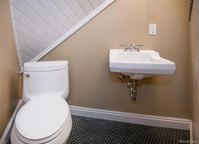 a bathroom with a sink toilet and a mirror