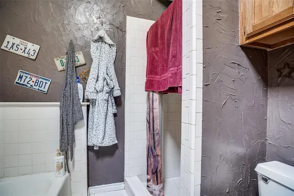 a bathroom with a shower and a sink