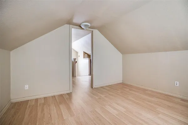 a view of a room with wooden floor and white walls