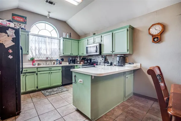 a kitchen with a sink cabinets and window