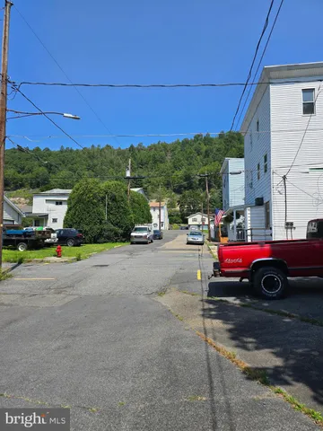a view of street with parked cars