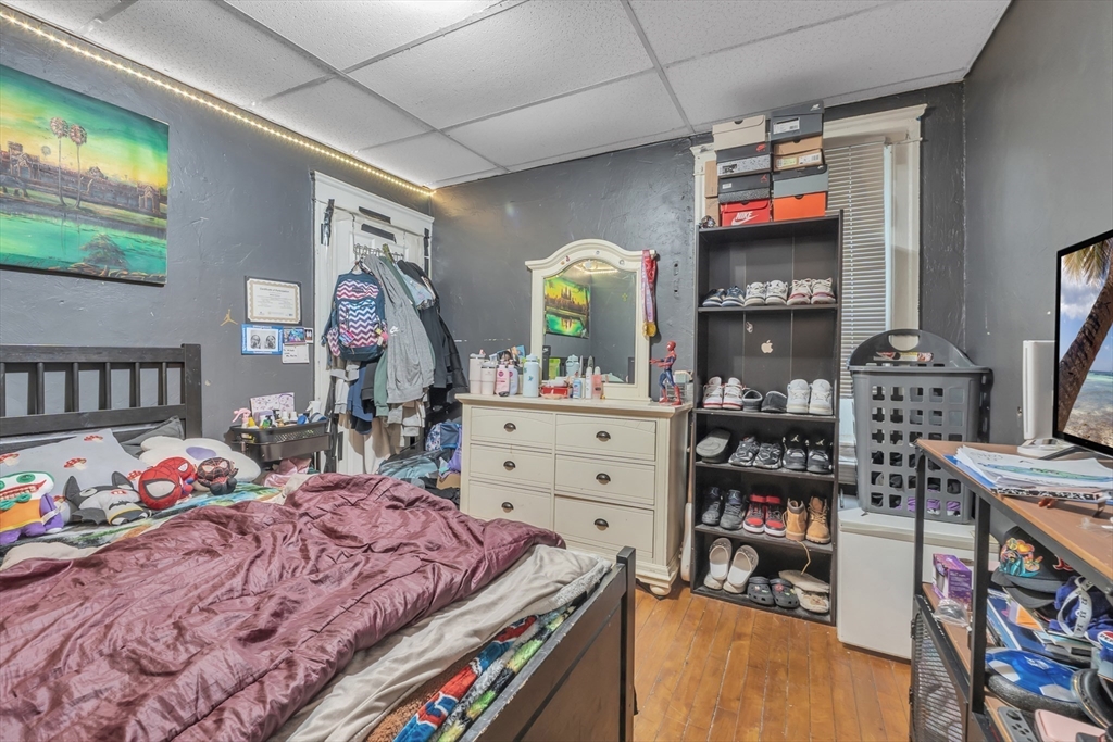 215 Beacon Street Worcester, MA 01610 - Photo 12 of 24 a bedroom with furniture and a flat screen tv