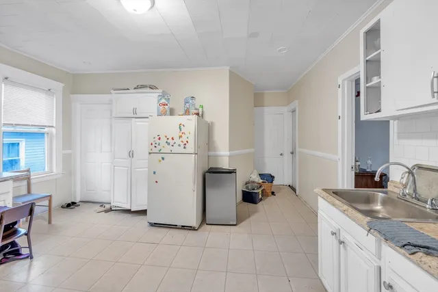 a kitchen with a refrigerator and a sink