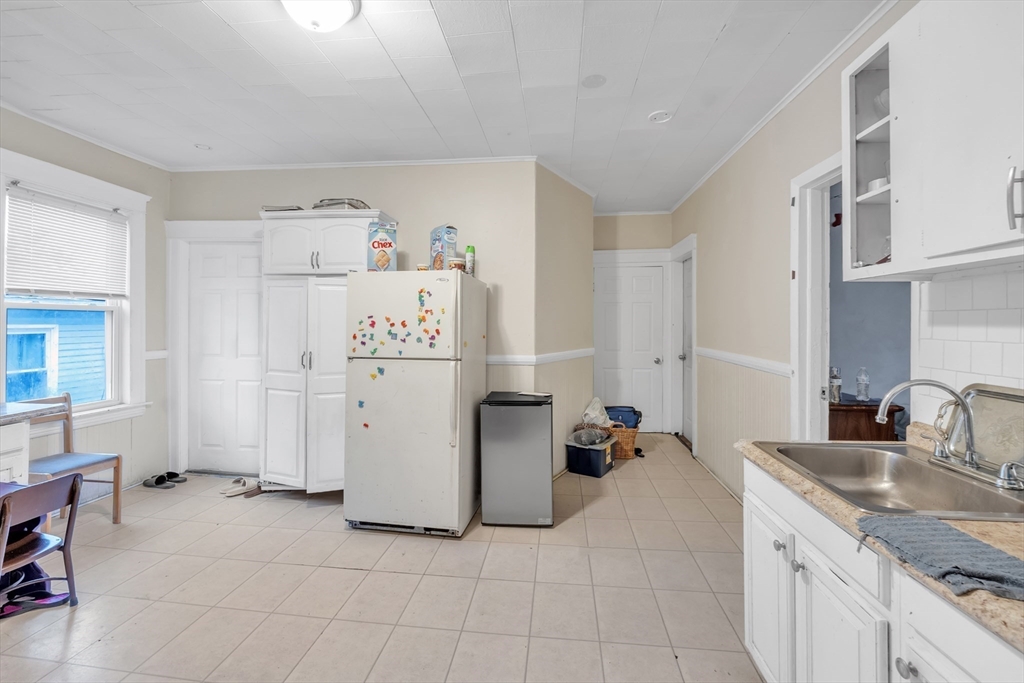 215 Beacon Street Worcester, MA 01610 - Photo 16 of 24 a kitchen with a refrigerator and a sink