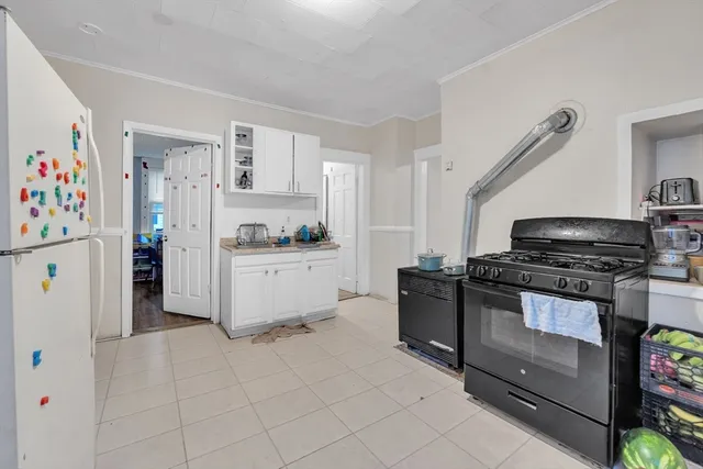 a kitchen with stainless steel appliances a stove a sink and a refrigerator
