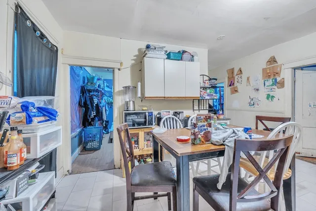 a view of a dining room with furniture and a kitchen